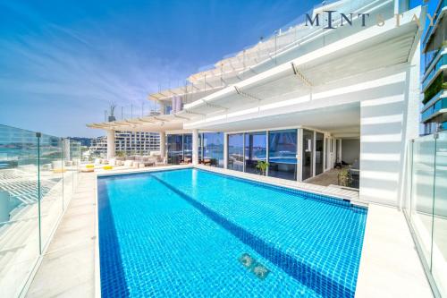 a swimming pool on the roof of a building at FIVE Palm Jumeirah Residences - Mint Stay in Dubai