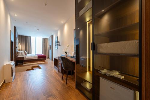 a hotel room with a bed and a desk at Hotel De‘Andros Virpazar in Virpazar