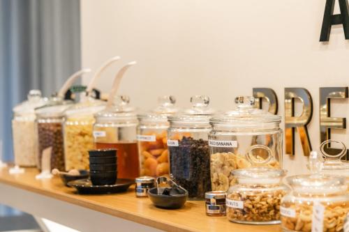 a shelf filled with jars of food on a counter at Nikon Boutique Hotel in Kalamaki