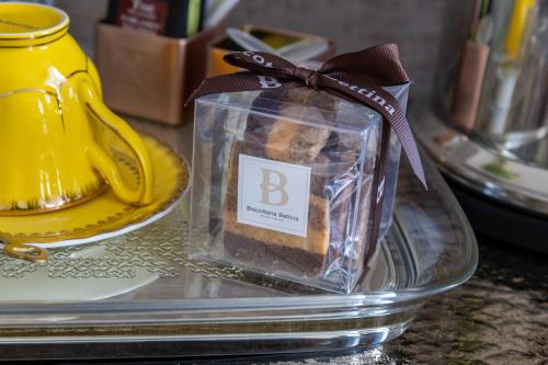 a candle in a glass container on a table at 286 Piazza San Marco - Relais il Doge in Venice
