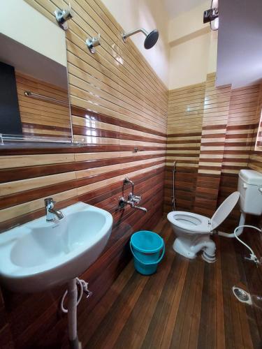 a bathroom with a sink and a toilet at Hotel Hari Gayatri Regent in Guwahati