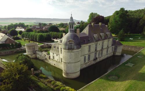 an old castle in the middle of a river at Le Château d'Etoges - Champagne in Étoges