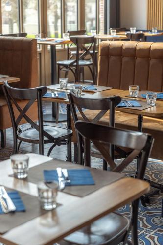 a row of tables and chairs in a restaurant at Le Château d'Etoges - Champagne in Étoges