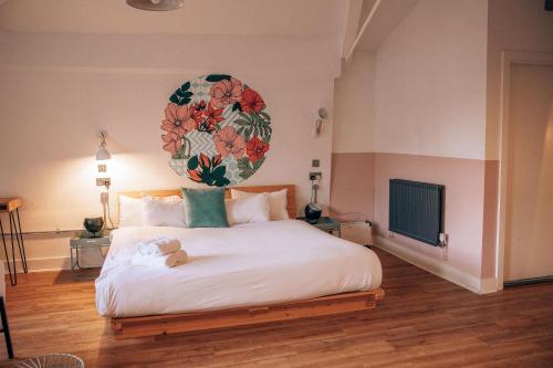 a bedroom with a large bed with a teddy bear on it at Malacuna Manchester in Manchester
