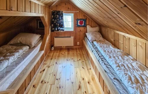 two beds in a room with wooden floors at Gorgeous Home In Eggedal With Kitchen in Haglebu