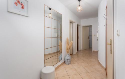 a hallway with a mirror and a vase at Cozy Apartment In Vantacici With House Sea View in Vantačići