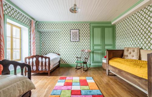 a bedroom with green walls and a bed and a chair at 5 Bedroom Gorgeous Home In Dommartin-le-saint-pr in Dommartin-le-Saint-Père