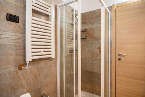 a shower with a glass door in a bathroom at Chalet Camping Faè 8 - Trilocale in Madonna di Campiglio