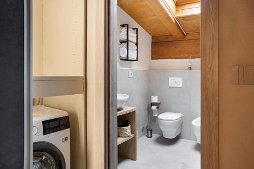 a bathroom with a washer and dryer and a washing machine at Locanda Ca Bianca - Family Suite in Roccabruna