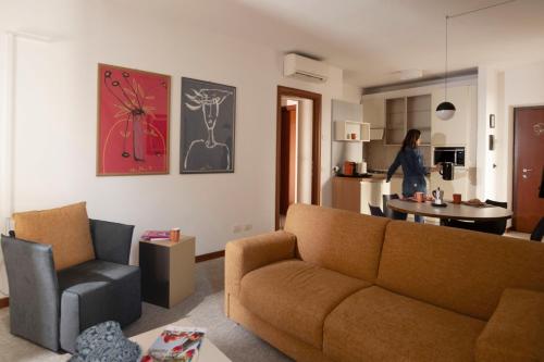 a living room with a couch and a chair at Appartamenti La Grotta in Bardolino