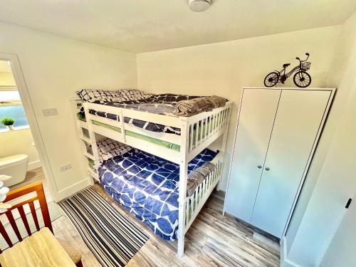 a bedroom with two bunk beds and a bike on the wall at Lux En-Suite COOP Arena ManCity Stadium Piccadilly in Manchester