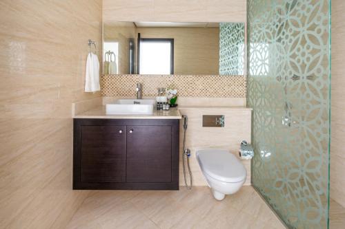 a bathroom with a toilet and a sink and a shower at Frank Porter - Mon Reve in Dubai