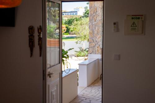 an open door with a view of a patio at Quinta da Relva - Soulful House in Mafra