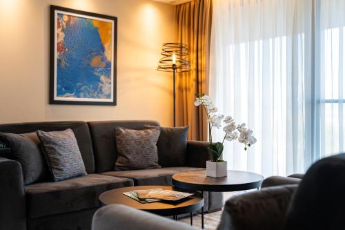 a living room with a couch and a table at Hotel De‘Andros Virpazar in Virpazar