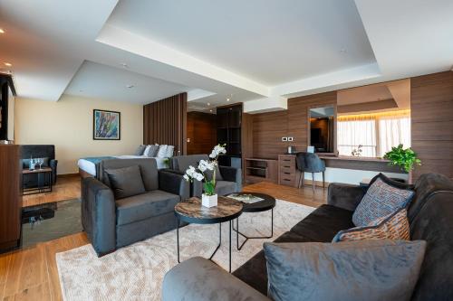 a living room with a couch and a table at Hotel De‘Andros Virpazar in Virpazar