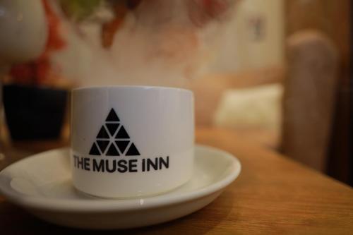 a coffee cup on a plate on a table at The Muse Pyramids INN in Cairo