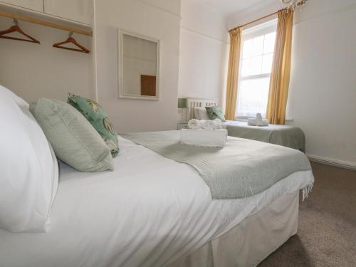 a bedroom with two beds and a window at Blue Yonder in Weymouth