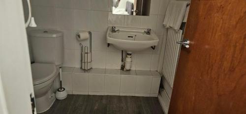 a small bathroom with a sink and a toilet at Farina No8, 3 bedroom Sea view apartment sleeping 7 guests in Bridlington