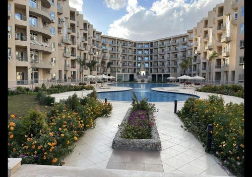 a large apartment complex with a courtyard with a swimming pool at Princess resort in Hurghada