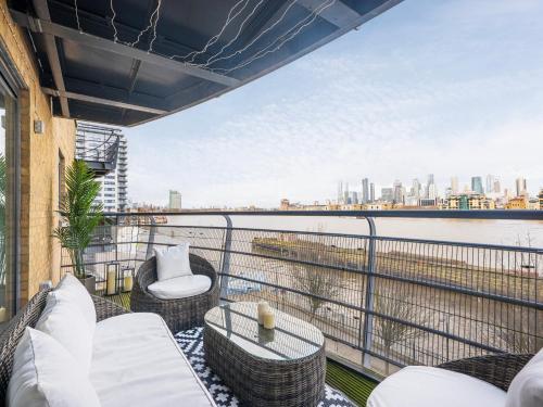 a balcony with a view of the water at The View Greenwich - Luxury River Thames Apartment in London