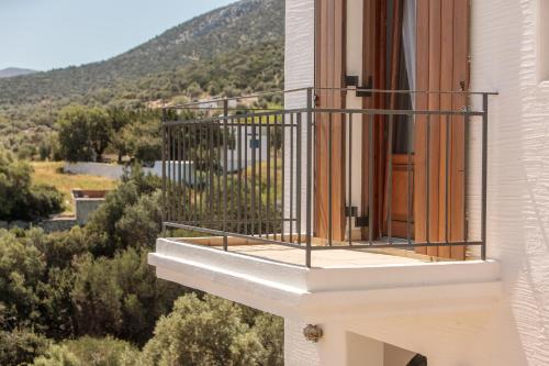 einen Balkon in einem Gebäude mit Blick auf die Bäume in der Unterkunft Apiliotis sunrise beach villa in Ligaridia