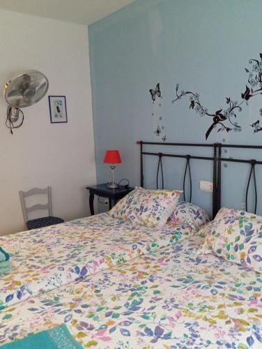 1 dormitorio con 1 cama con un edredón colorido en CASA el NOGAL, en Salas Bajas
