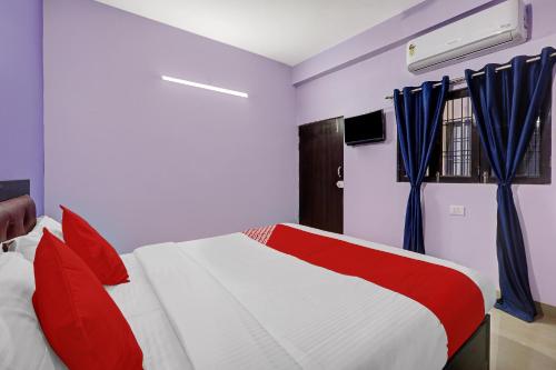 a bedroom with a white and red bed and a window at OYO Flagship 24 Stays in Chinhat