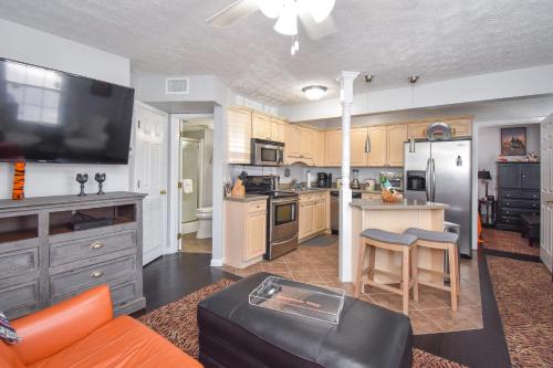 a large kitchen with an orange couch and a table at Stadium View in Auburn