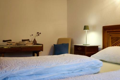 a bedroom with a bed and a desk with a guitar at Antica Osteria Dazio in Fusio