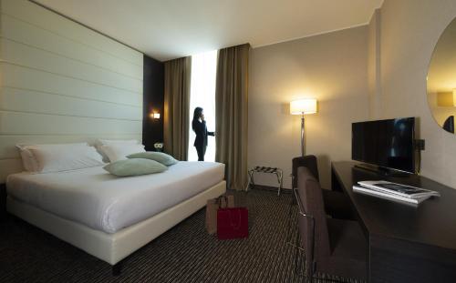 Postel nebo postele na pokoji v ubytování H2C Hotel Milanofiori