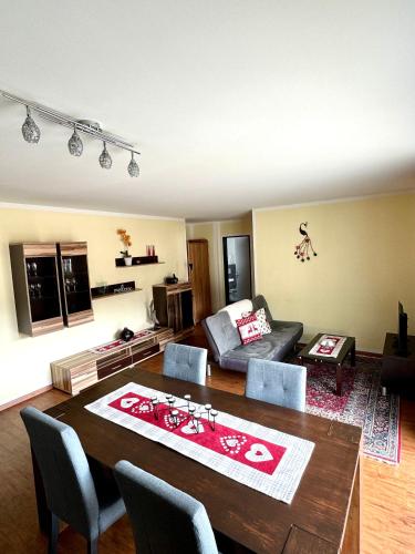 a living room with a table and a couch at Aladin Apartments St Moritz in St. Moritz