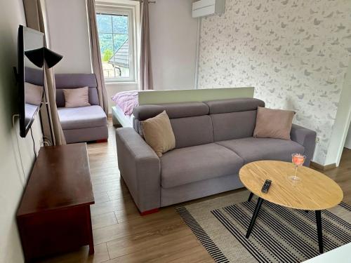 a living room with a couch and a table at Mountain View in Bovec