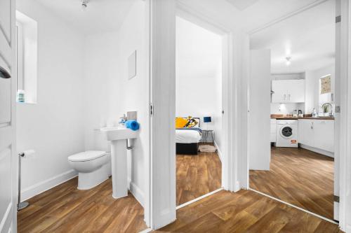 a bathroom with a toilet and a sink at Perfect house for large groups and families in Leicester