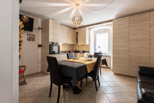 a kitchen and dining room with a table and chairs at Casa Nico in Tassullo
