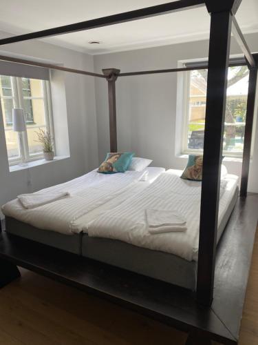 a large bed in a room with a large window at Brohuspark in Lomma