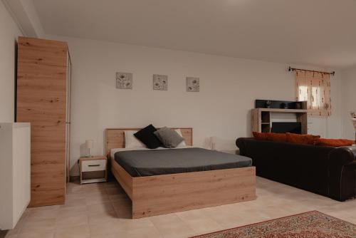 a bedroom with a bed and a couch at Saint Nektarios Ηouse Preveza in Preveza