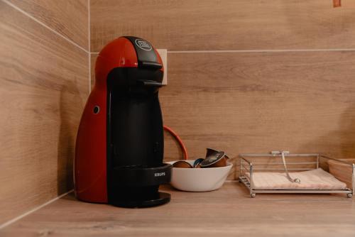 a red and black mixer sitting on a counter at Saint Nektarios Ηouse Preveza in Preveza