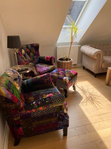 a living room with a couch and a chair at Brohuspark in Lomma
