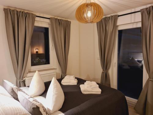 a bedroom with a bed with white pillows and a window at Ferienwohnung - Zum alten Fritz - Suhl, 2 Schlafzimmer, 2 Terrassen in Suhl