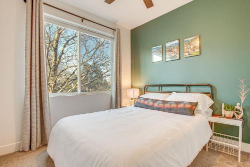 a bedroom with a bed and a large window at Modern Denver Vacation Rental with Rooftop Deck! in Denver
