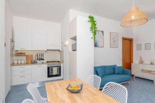 a kitchen and living room with a table and chairs at Villa Marea in Praiano