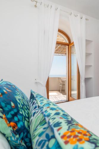 a room with a bed with a view of the ocean at Villa Marea in Praiano
