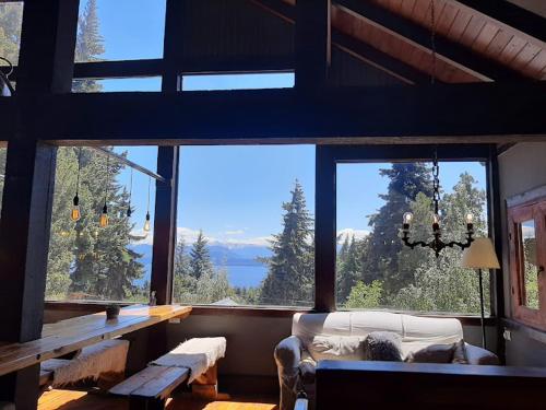 a living room with a large window with a view at Alojamiento en Aldea Andina in San Carlos de Bariloche