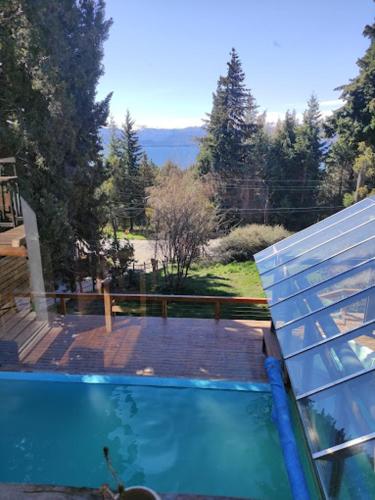 a swimming pool with a view of a yard at Alojamiento en Aldea Andina in San Carlos de Bariloche
