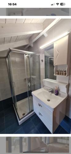 a bathroom with a shower and a white sink at Maria’s family house’s in Elafonisos