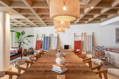 a large wooden table in a room with chairs at Zel Mallorca in Palmanova
