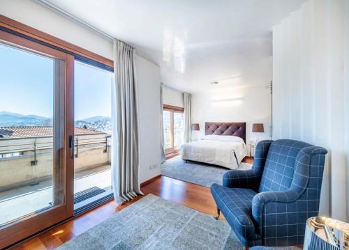 a bedroom with a bed and a large window at Villa Vanessa SUITES in Lugano