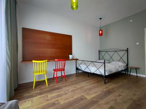 a bedroom with two chairs and a bed and a table at Hostel Charming Double Private Room in Pristina