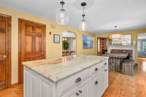 a kitchen with a large white island in a room at 4 Lookout Point Road Plymouth Z Ocean House in Sandwich