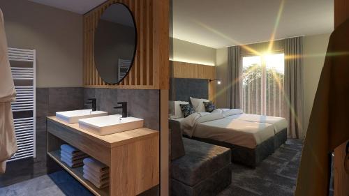 een badkamer met een wastafel, een bed en een spiegel bij Familienresort Reslwirt in Flachau